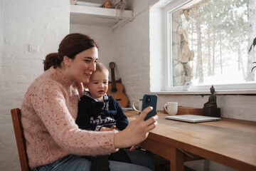 Mother With A Baby Boy Making A Video Call