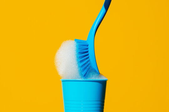 dishwashing brush with soap in a plastic cup