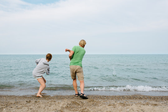 Dad and daughter rock skipping