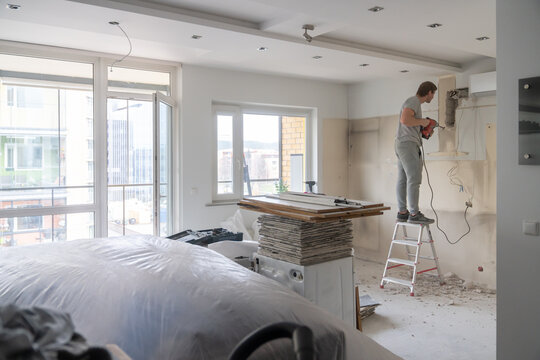 Handyman Using Drill While Doing Renovation 