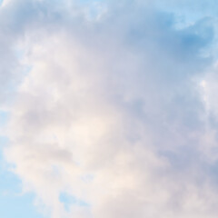 Background of blue sky with white pink clouds at sunset