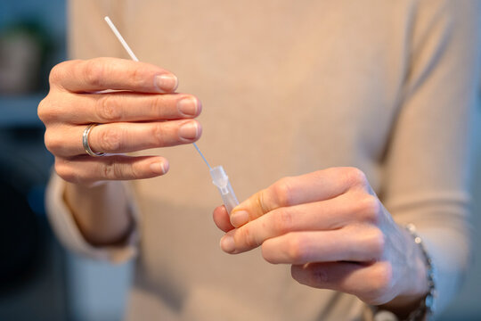 Crop woman doing antigen test