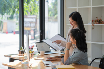 Portrait of two professional business teams planning their strategy together in modern office room