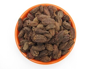 Black cardamom in a bowl top view 