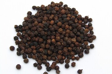 Black peppercorn on white background 