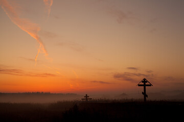 Obraz na płótnie Canvas Holy concept: Silhouette wooden cross on mountain sunset background