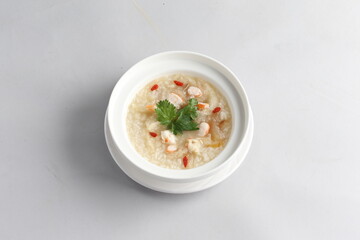 healthy seafood prawn herbal poached rice porridge soup in bowl on white background chinese banquet halal menu