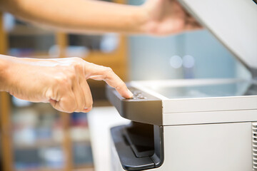 Copier printer, Close up hand office man press copy button on panel to using the copier or photocopier machine for scanning document printing a sheet paper and xerox photocopy.