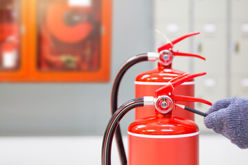Fire extinguisher has hand engineer inspection checking pressure gauges to prepare fire equipment...