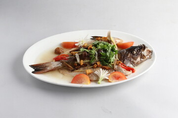 teo chew steamed whole fresh red grouper fish in salted vegetable tomato sauce chinese banquet halal seafood menu on white background