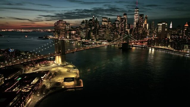 alt dusk view of downtown NYC flying backwards over Manhattan Bridge