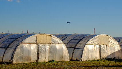 giant passenger aircraft starting over greenhouses in vienna