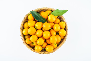 Bamboo basket full of fresh kumquats on white background