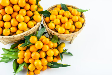 Bamboo basket full of fresh kumquats