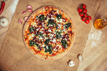 Tasty pizza on wooden background