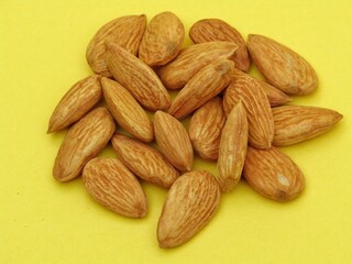 Almonds on yellow background 