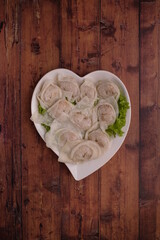 chef handmade fresh seafood meat pork ball dumpling in frozen and hot soup bowl on wood background top view chinese menu