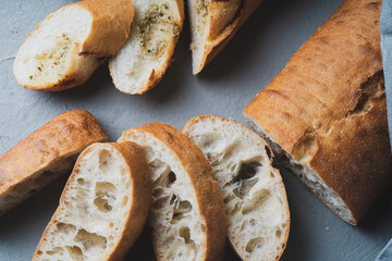 Freshly baked homemade bread with crispy crust on gray background