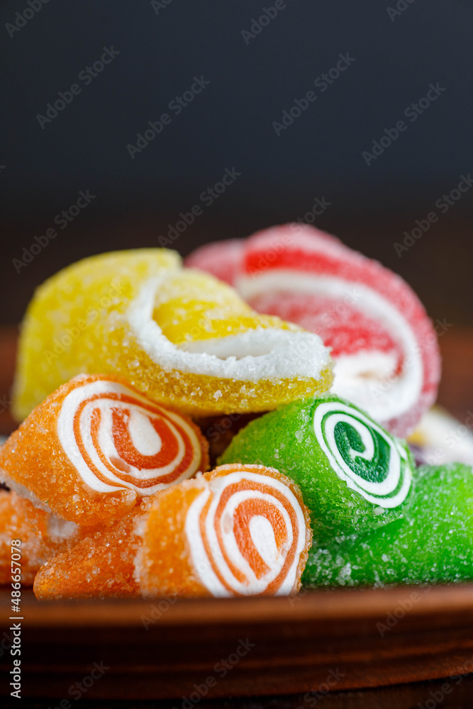 Wall mural beautiful multicolored turkish delight on a brown ceramic plate. turkish sweets . delicious colorful