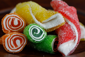 Beautiful multicolored Turkish delight on a brown ceramic plate. Turkish sweets .