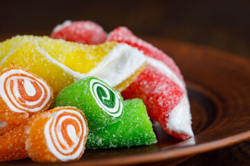 Beautiful multicolored Turkish delight on a brown ceramic plate. Turkish sweets . Delicious...