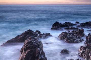Water with rock nature photo with long exposure fog effect abstract color ocean background 
