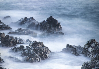 Water with rock nature photo with long exposure fog effect abstract color ocean background 
