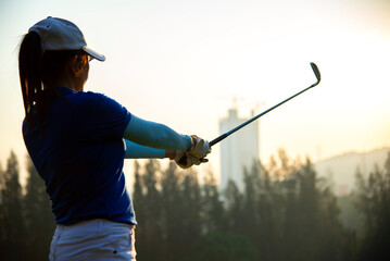 Golfer Woman playing golf People swing and hitting golf course is on the fairway. Hobby in holiday and vacations on club golf. Lifestyle and Sport Concept