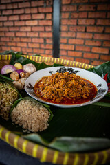 Rendang serai or we call it rendang lemongrass plating on white plate for eid mubarak with a spicy seasoning. 