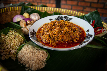 Rendang serai or we call it rendang lemongrass plating on white plate for eid mubarak with a spicy seasoning. 