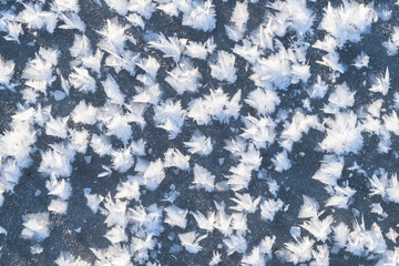 snow feathers on the surface of a frozen river