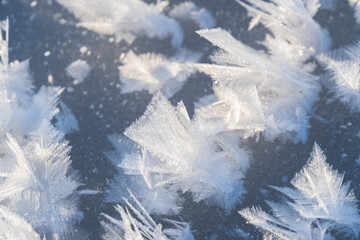 snow feathers on the surface of a frozen river