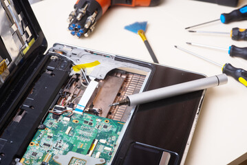 Wizard repairs laptop with tools and hands