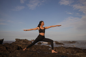 Slim Asian woman practicing Virabhadrasana II, Warrior II Pose. Yoga retreat. Healthcare concept....