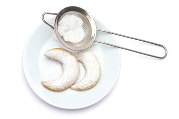 Traditional German or Austrian Vanillekipferl vanilla kipferl cookies on a plate isolated on white background