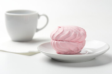 Dessert. Pink marshmallow on a white background.