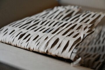 A close-up of the perforated wrapping cardboard. Recycled raw material for parcel packaging. The...