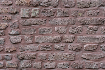 The texture of the old brickwork painted in pink. Close-up. Details. creative background