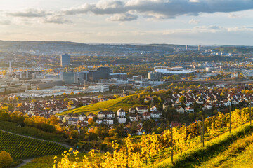 Germany, Stuttgart city  skyline panorama landscape view above industry, houses, streets, arena in basin at sunset