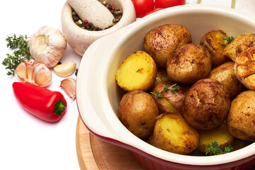 Baked potato in a clay pot isolated on white background