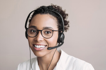 Young woman wearing headset. Portrait of customer service assistant talking on phone. Video...