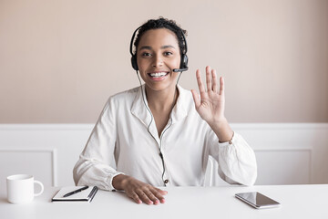 Beautiful business woman looking and speaking through the web camera while making a video conference from office or home - obrazy, fototapety, plakaty