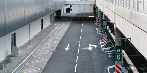 underground parking lot with public transport marked in yellow line and concrete poles with special signs upper view © Bonsales