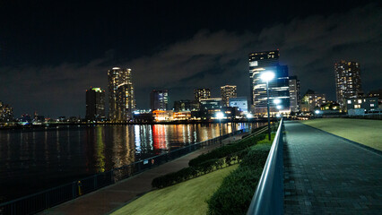 Night view of a high-rise condominium along an urban river_02