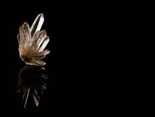 formation of quartz crystals. You can see the reflection on a black support and a black background....