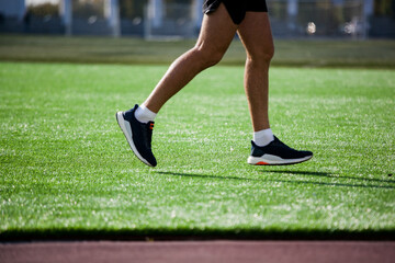 a white man in black shorts and white running at the stadium