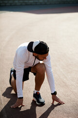 a white man in black shorts and white running at the stadium