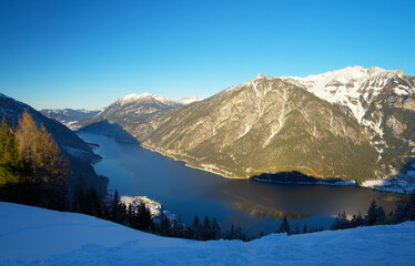 top view of the Achensee from a mountain top on a sunny winter day