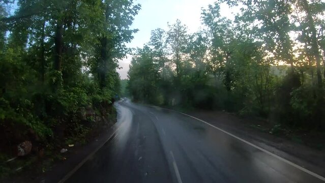 4K POV Hyper lapse of the dashcam of vehicle with dirty windshield moving through the green forests of the Dang district on the way to Saputara in Gujarat, India. Hyper lapse of car moving in forest. 