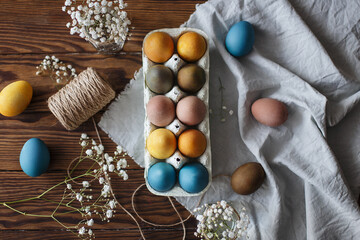 Easter eggs in a box on a beautifully decorated table with flowers